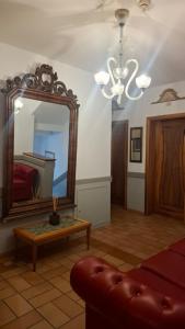 a living room with a mirror and a couch at Hotel Villa Fanti in Loreto