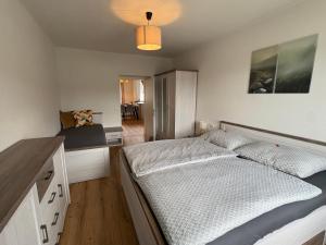 a bedroom with a large bed and a desk at Tom s Apartment II in Knittelfeld