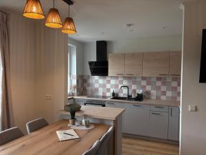 a kitchen with a wooden table and a counter top at Tom s Apartment II in Knittelfeld