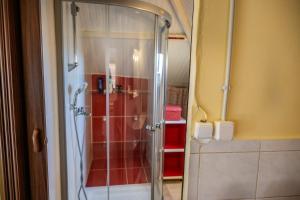 a shower with a glass door in a bathroom at Foothills loft in Keratea +53 photos