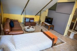 a living room with a couch and furniture in a room at Foothills loft in Keratea