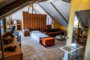 a living room with a bed and a couch at Foothills loft in Keratea