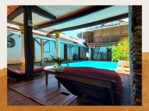 a living room with a pool in a house at Hotel Les Boucaniers in Ambatoloaka