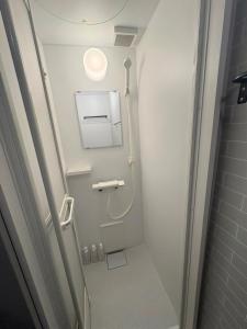 a small bathroom with a shower and a toilet at 若葉コーポ in Fukuoka +27 photos