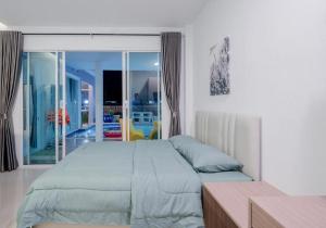 a bedroom with a large bed and a balcony at พลอยพูลวิลล่า ชะอำ 1 Ploy Poolvilla Cha-am 1 in Cha Am +58 photos