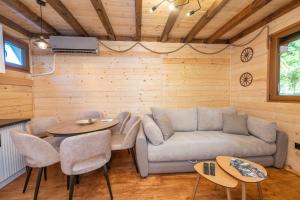 a living room with a couch and a table at Brvnara Iva Kolašin Crna Gora in Selišta