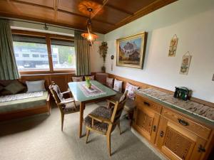 a living room with a table and chairs and a couch at Ferienhaus Greti Ehrwald in Ehrwald