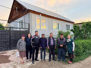 a group of people standing in front of a house at Darhan Guest House in Darkan