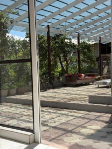 a glass door of a building with a patio at Darhan Guest House in Darkan