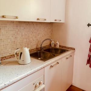 a kitchen with a sink and a counter top at BaBi in Cison di Valmarino