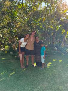 a family posing for a picture in the grass at Green Villa Midigama in Midigama East