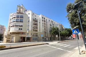 a large building on the side of a street at Casa Caravela C in Armação de Pêra
