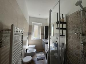 a bathroom with a toilet and a sink and a shower at Casa dolce Casa in Rapallo +18 photos