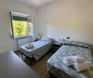 a hotel room with two beds and a window at Casa dolce Casa in Rapallo