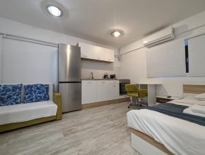 a large bedroom with a bed and a kitchen at Cozy Studio in Downtown Sesvete in Sesvete
