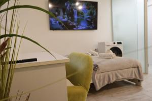 a hospital room with a bed and a chair at Cozy Studio in Downtown Sesvete in Sesvete