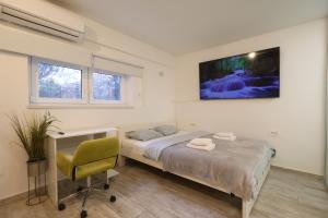 a bedroom with a bed and a chair in it at Cozy Studio in Downtown Sesvete in Sesvete