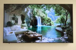 a waterfall in the middle of a living room with a couch at Cozy Studio in Downtown Sesvete in Sesvete