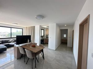 a living room with a table and a couch at Flamingo Vacation Rentals in Paphos