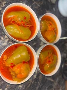 a group of four bowls of soup on a table at Asylbek Guesthouse horseback riding tours in Kyzart