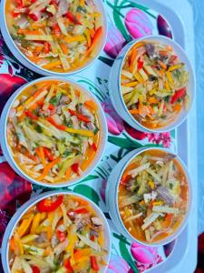 a group of four bowls of soup with vegetables at Asylbek Guesthouse horseback riding tours in Kyzart