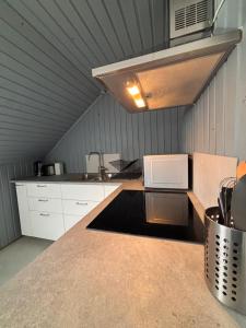 a kitchen with a counter top with a microwave at Studio by the river in Forshaga