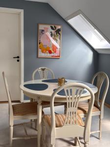 a dining room with a white table and chairs at Studio by the river in Forshaga