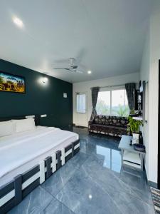a bedroom with a large bed and a living room at Villa Tesori Homestay Wayanad in Meppādi +56 photos