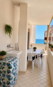a bathroom with a table and a sink and a view of the ocean at CASA Di MIRKO in Gallipoli