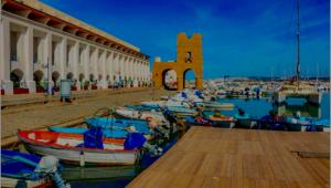 a group of boats in a harbor next to a building at Villa Samia in Staoueli