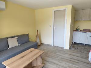 a living room with a couch and a table at Iza sedam gora in Rakovac +38 photos