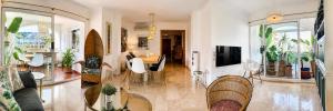 a living room with a table and chairs at Beach Penthouse Apartment in Jávea