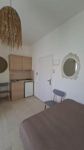 a room with a kitchen and a bed and a table at Villa Sylvia 1 in Matala