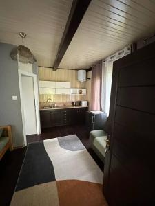 a room with a kitchen with a door and a rug at Guest House Villa Arkadia in Warsaw