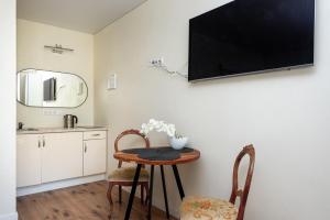 a small table with two chairs and a tv on a wall at 2rest in Palanga +74 photos