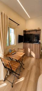 a room with a table and chairs and a television at Olvaya in Bzîza