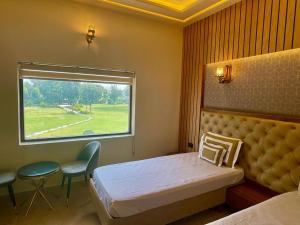 a hospital room with a bed and a window at Shakti Resort in Behror