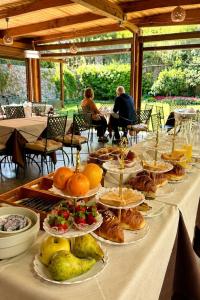 a long table with plates of food on it at Giardini Calce - Luxury Rooms in Ravello