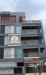 a building with a sign on the side of it at Royal Residency in Vākalapūdi