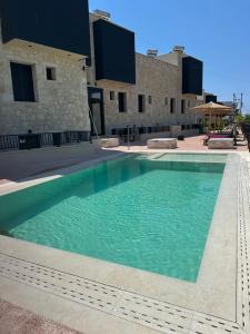 a swimming pool in front of a building at RCR The Stones in Flogita