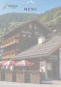 a building with red umbrellas in front of it at Hôtel-Restaurant Mélèze Grimentz in Grimentz +12 photos