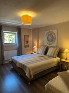 a bedroom with a large bed and a window at Weinburg -Das Ferienhaus in Cochem