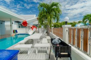 a balcony with a pool and a water slide at พลอยพูลวิลล่า ชะอำ 2 Poolvilla Cha-am 2 in Cha Am