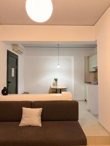 a living room with a couch and a table at Skala Apartments in Agia Marina Nea Kydonias