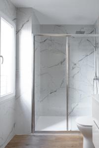 a shower with a glass door in a bathroom at YES! Rooms in Alicante +24 photos