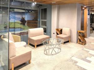 a room with two chairs and a glass table at Kokotel Cebu Capitol in Cebu City