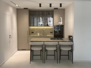 a kitchen with a island with bar stools at Nitza 14 in Netanya