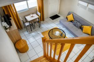 a living room with a couch and a table at le duplex de l'Hôtel de ville in Lourdes