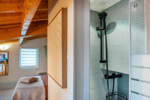 a bathroom with a shower and a glass door at le duplex de l'Hôtel de ville in Lourdes +29 photos