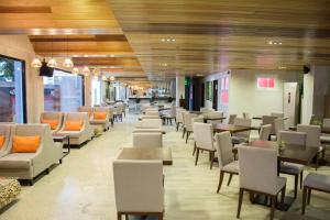 a waiting room with chairs and tables in a building at Kokotel Cebu Capitol in Cebu City